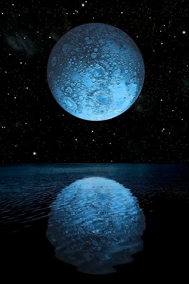 A Blue Moon Rising Over A Calm Ocean Wall Art